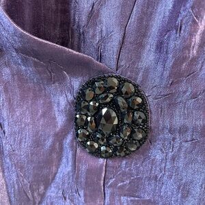 Dressy lightweight top with lovely embellishment.